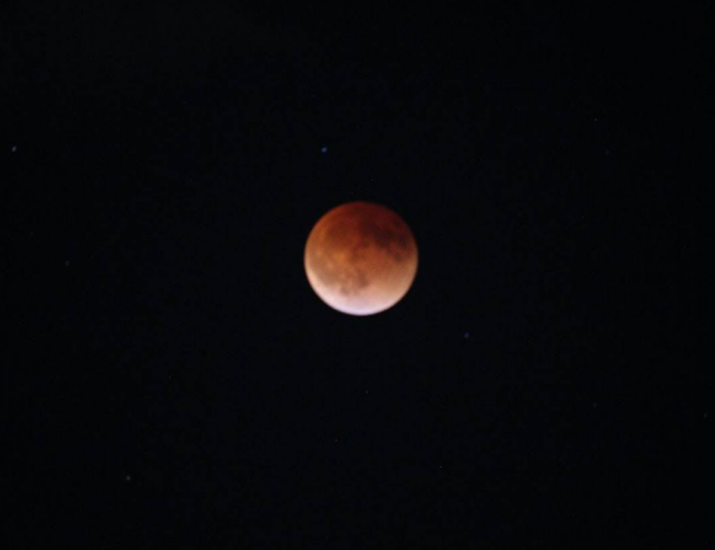 The full Moon is covered by a dark red shadow during a total lunar eclipse