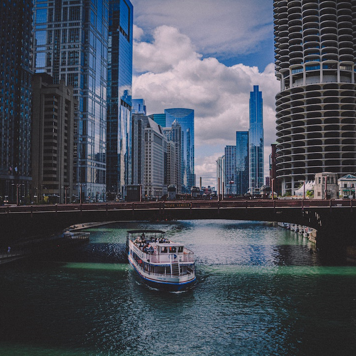 Image caption: Water taxi passing underneath a bridge on the Chicago River. Image credit: Jake Leonard